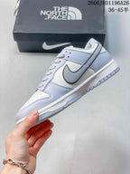 Nike SB Dunk Low Sneakers in White and Gray