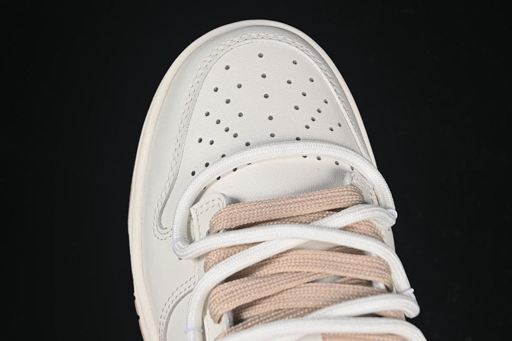 Nike SB Dunk Low Sneakers in White and Soft Pink