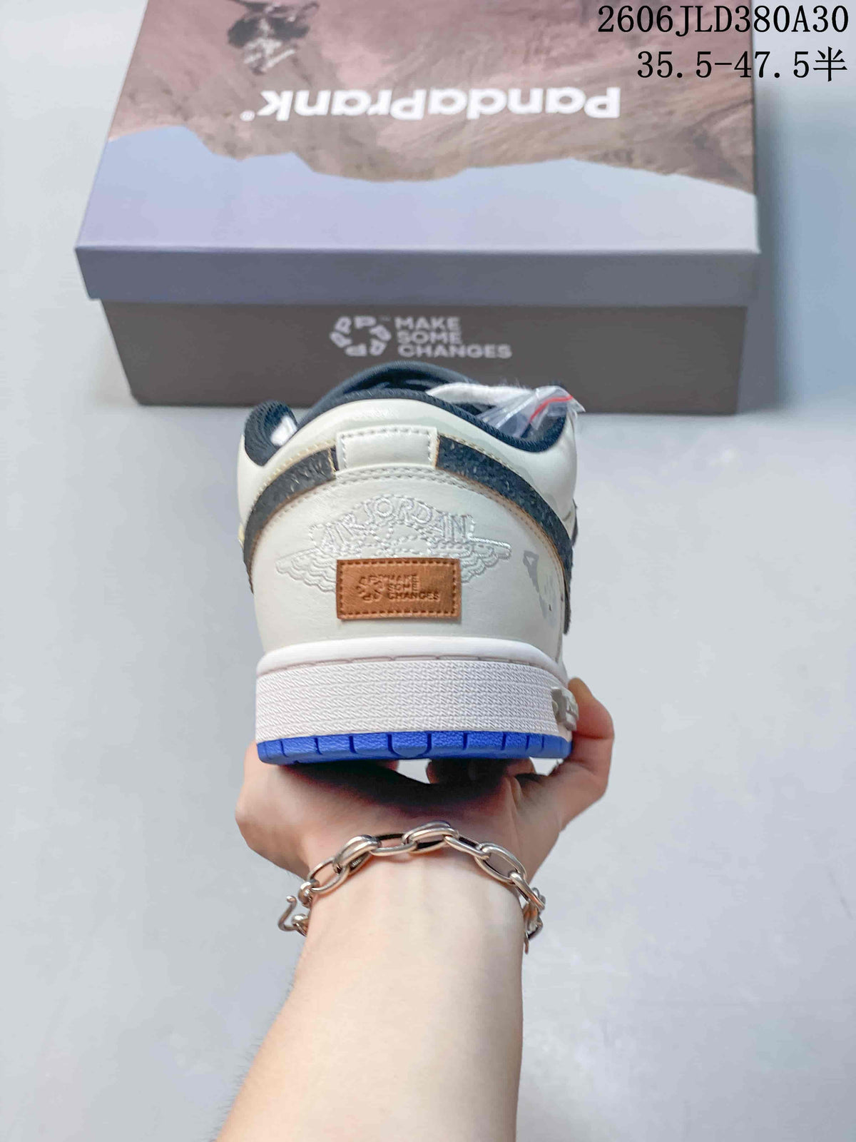 Jordan AJ1 Low Panda Prank Sneakers in White and Blue