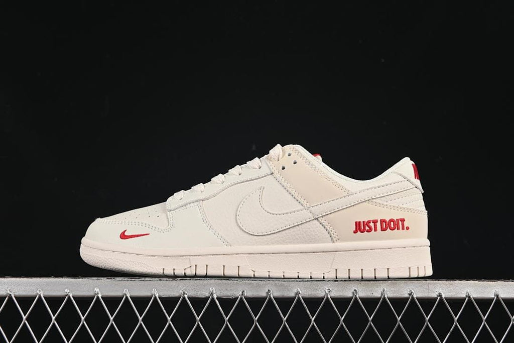 Nike SB Dunk Low Sneakers in White with Red Accents