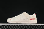 Nike SB Dunk Low Sneakers in White with Red Accents