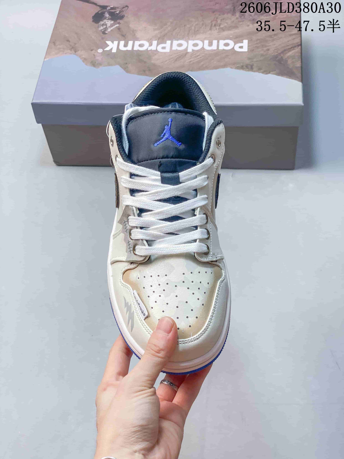 Jordan AJ1 Low Panda Prank Sneakers in White and Blue