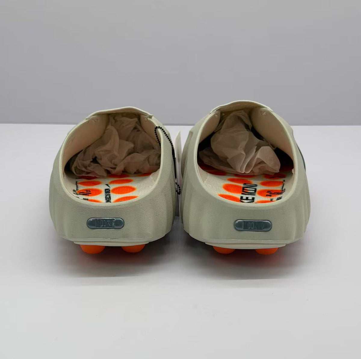 Nike Beige Slip-On Sandals with Orange Sole Details
