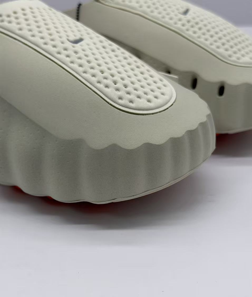 Nike Beige Slip-On Sandals with Orange Sole Details