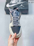 Jordan 1 Low Graffiti Sneakers in Gray and Cream