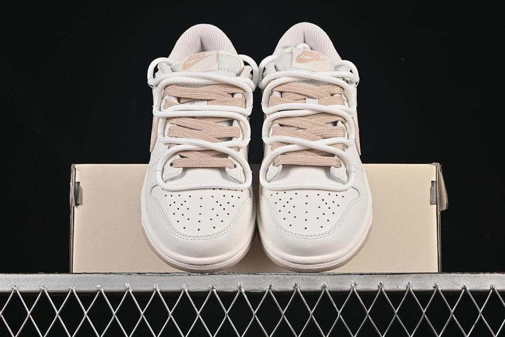 Nike SB Dunk Low Sneakers in White and Soft Pink