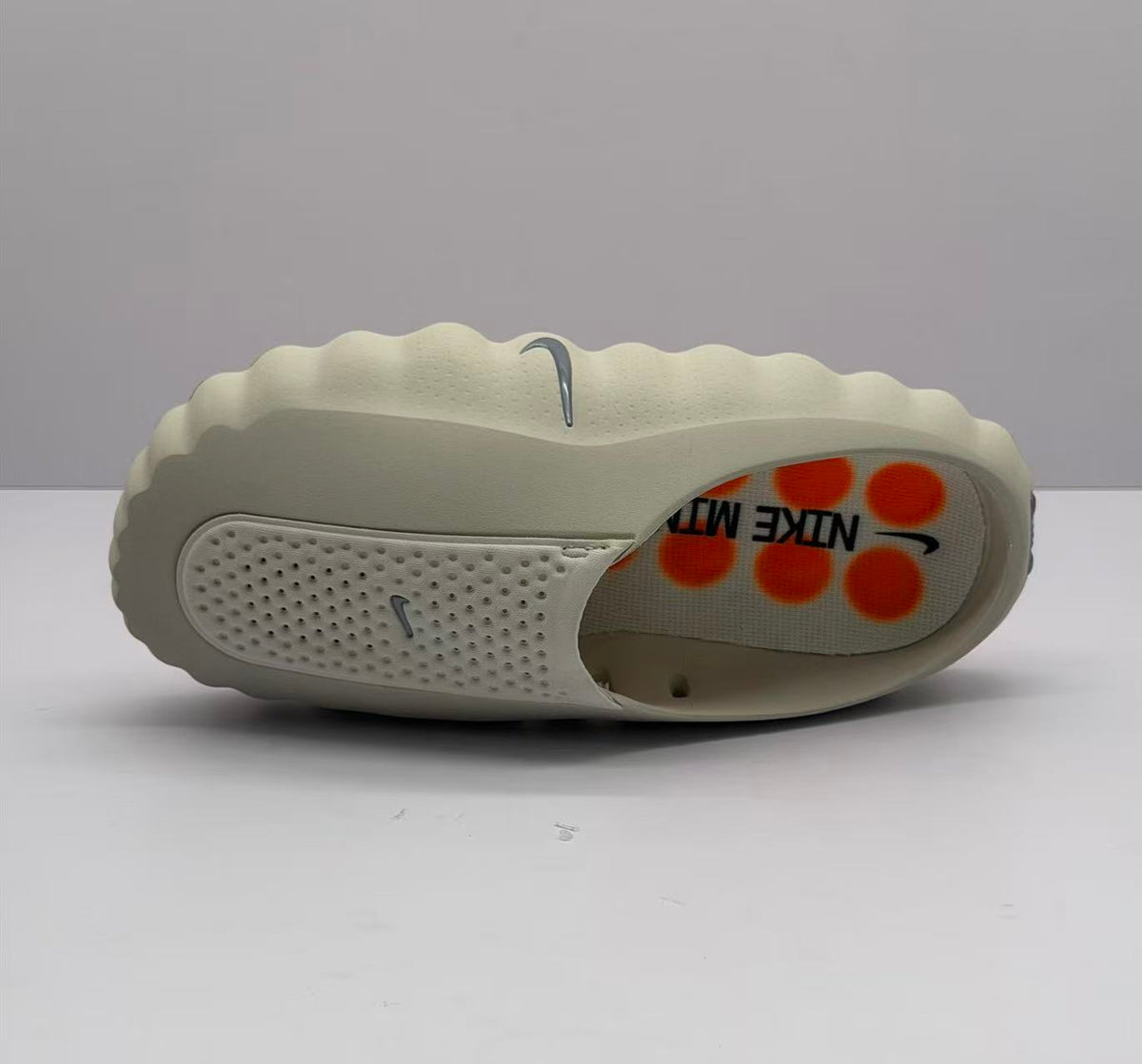 Nike Beige Slip-On Sandals with Orange Sole Details
