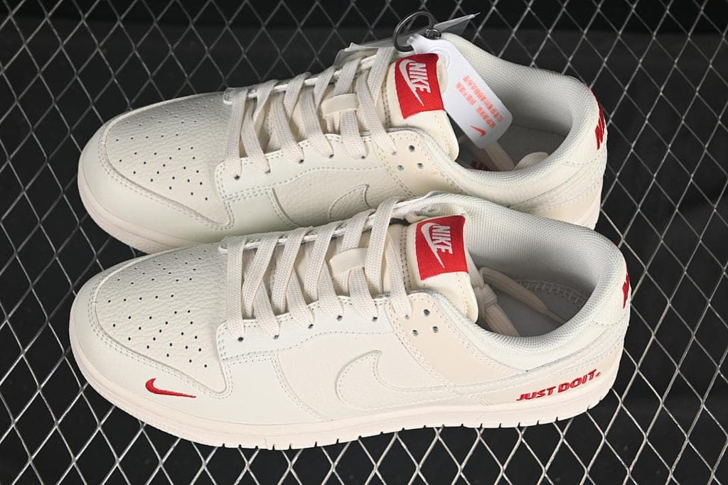 Nike SB Dunk Low Sneakers in White with Red Accents