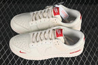 Nike SB Dunk Low Sneakers in White with Red Accents