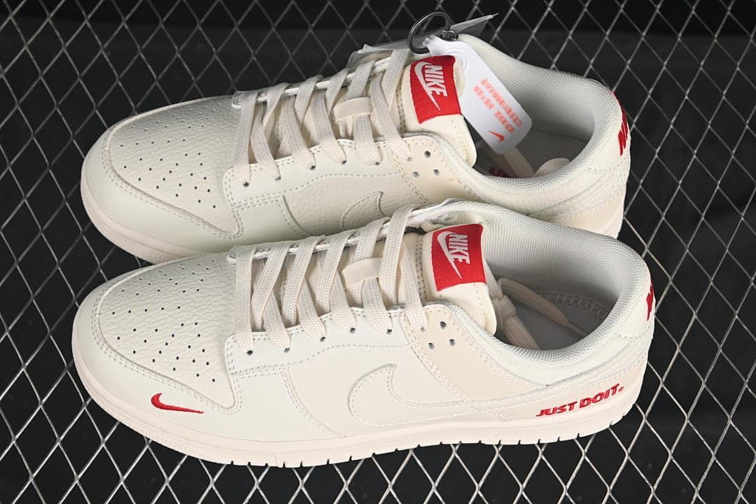 Nike SB Dunk Low Sneakers in White with Red Accents
