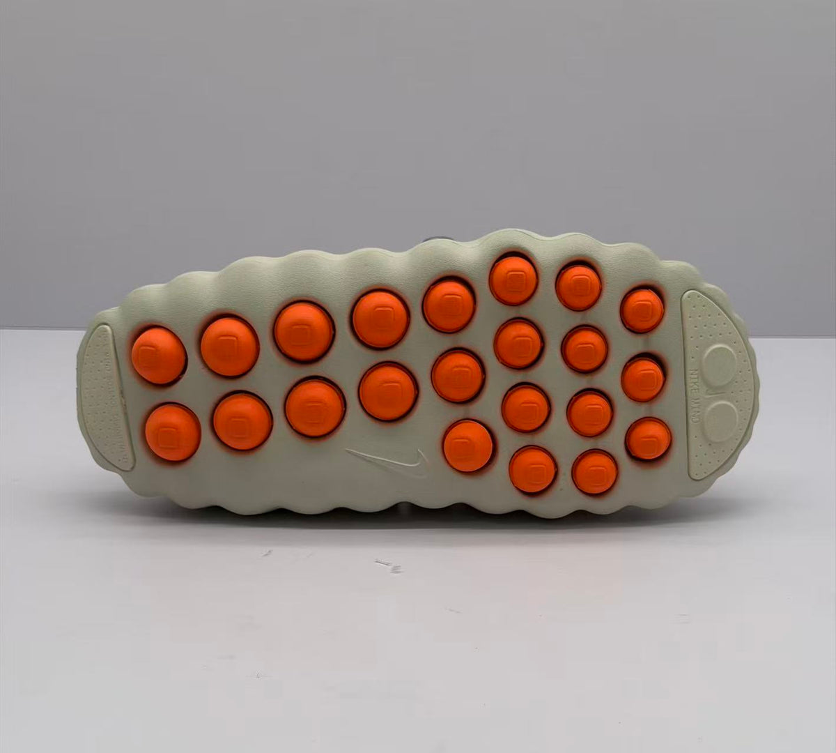 Nike Beige Slip-On Sandals with Orange Sole Details