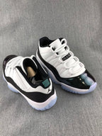 Jordan 11 Low Sneakers in White and Black